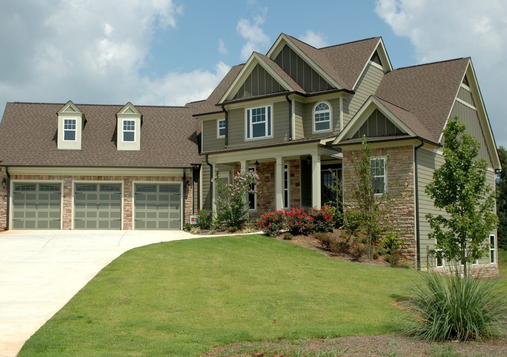 VA jumbo loan - Two-story house with white siding and grey roofing.